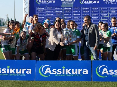 Malta FA General Secretary Maria Azzopardi and Assikura Insurance Brokers PLC Managing Director present the trophy to Mġarr United captain Abigail Camilleri - (c) Lara Schembri